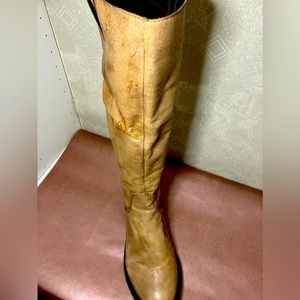Leather Knee high boots in tan/cognac with gold accents.